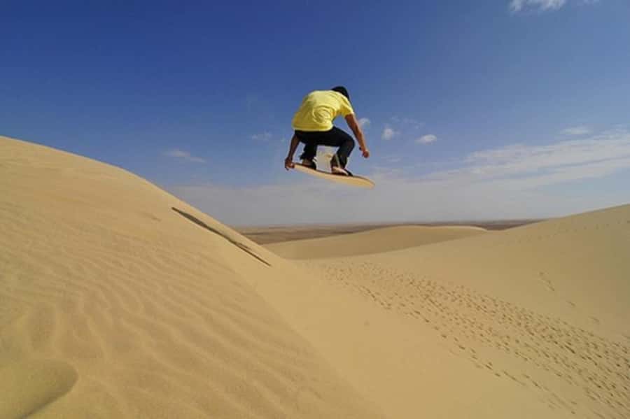 Desert Safari, Quad Bike, Camel Ride, Falcon & Sandboarding - Sandboarding from the higher dunes