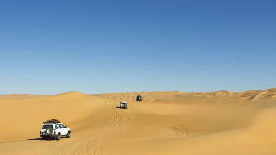 Doha: Desert Safari with Dune Bashing and Inland Sea - Sunset over the rolling dunes