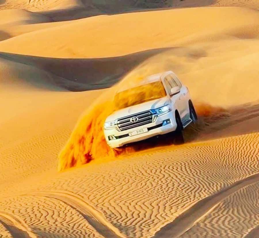 Doha: Sunset Desert Safari with Camel Ride & Sandboarding - What dune bashing feels like in practice